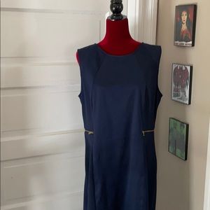 Navy sleeveless dress with gold accent zippers